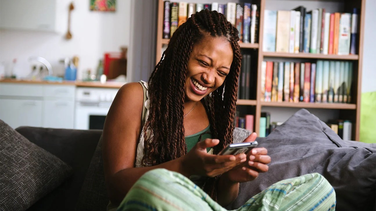 woman laughing at funny Twitter accounts